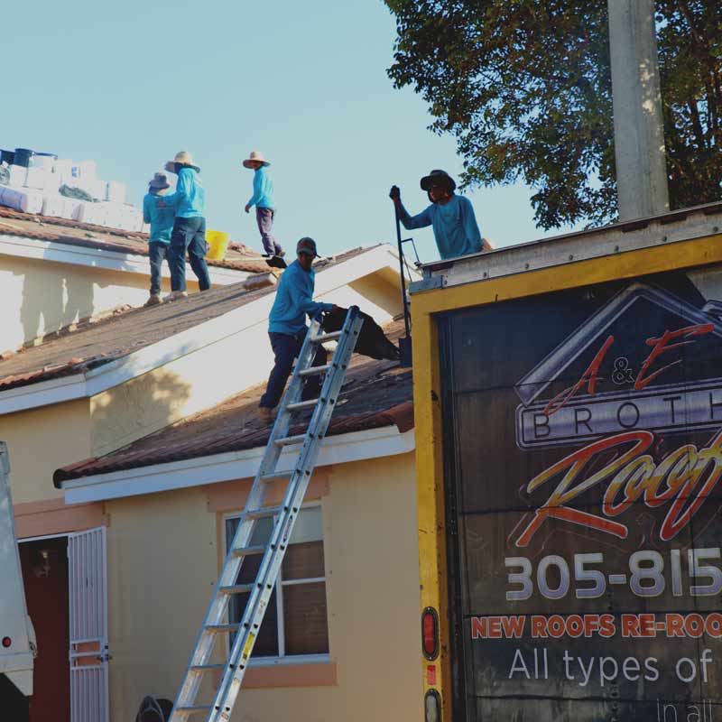 ae brothers roofing laborers tearing old roof off for re-roof