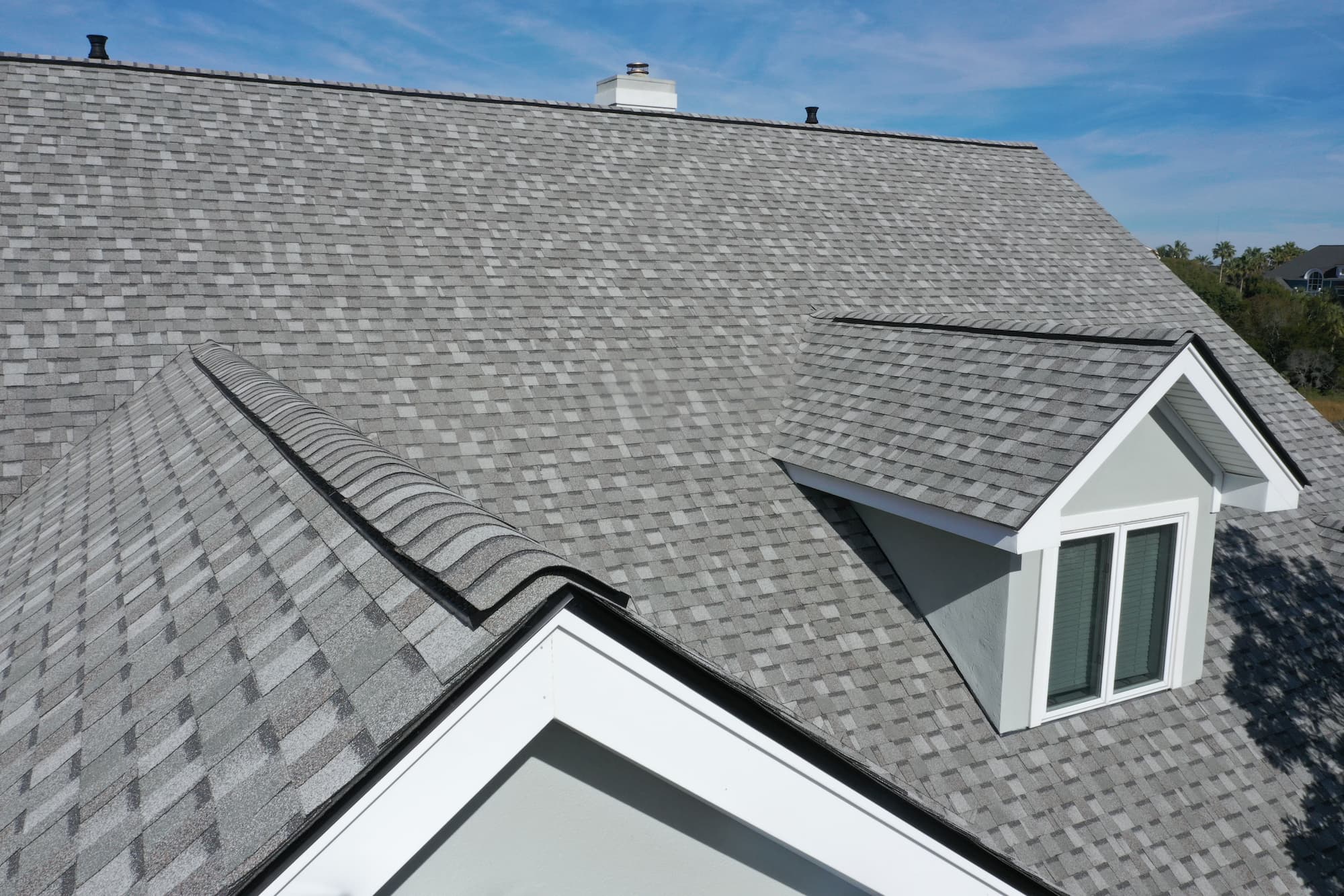 Daytime photo of new grey roof of a home
